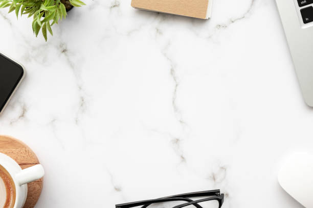 istock White marble office desk table with a lot of things on it. Top view with copy space, flat lay. 1303482720