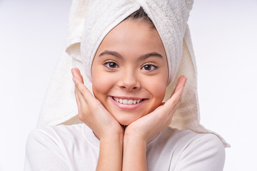 Close up portrait of a teenage girl in spa towel isolated over white background