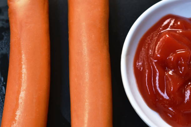 istock fried pork sausage slice dipping with ketchup 1303484660