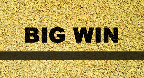 Big win concept background. Message in yellow grunge wall