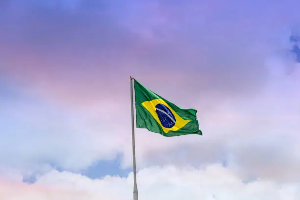 Goiania, Goias, Brazil – February 21, 2021: Flag of Brazil, raised and waving in the wind with sky in the background.