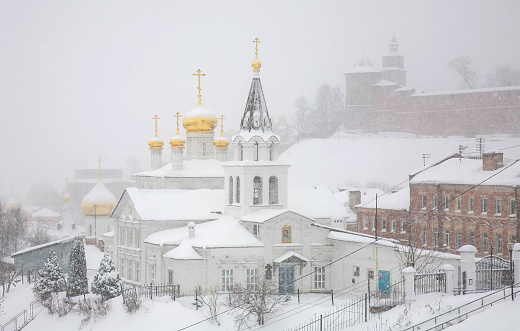 View of the winter Orthodox Church and the Kremlin of Nizhny Novgorod in a snowstorm