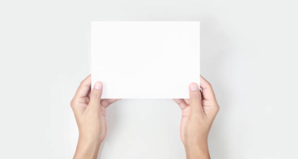 istock Hands holding paper blank for letter paper 1303491298