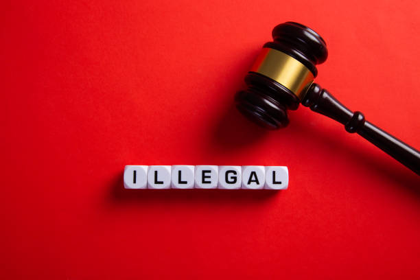 istock Illegal word on red background. Immigration law. 1303493063