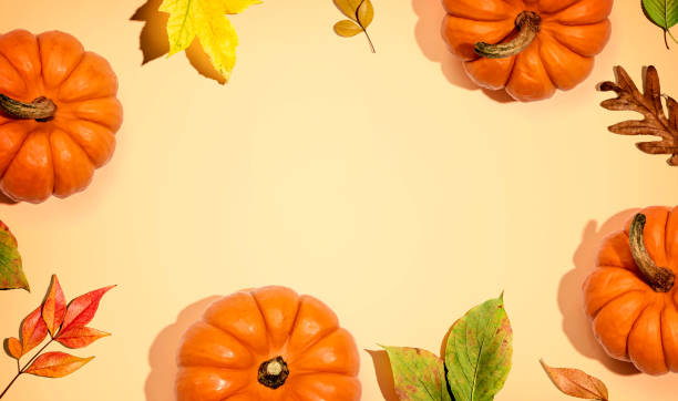 istock Autumn pumpkins with colorful leaves overhead view 1303496329