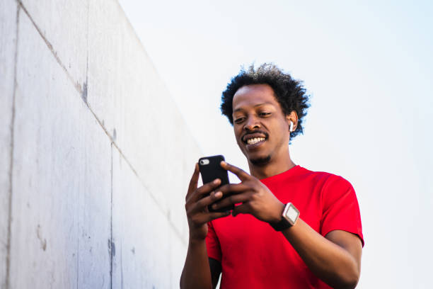 istock Athlete man using his mobile phone outdoors. 1303497713