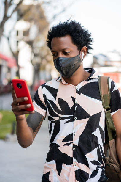 istock Tourist man using his mobile phone outdoors. 1303497785