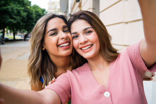 istock Two friends taking a selfie outdoors. 1303497817