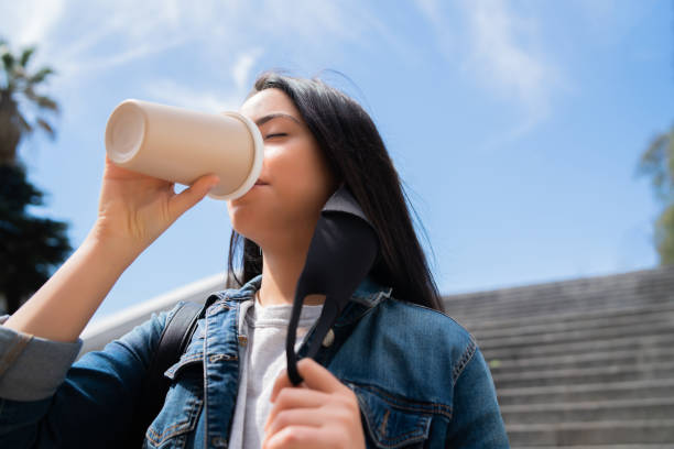 istock Young woman drinking a cup of coffee. 1303497890