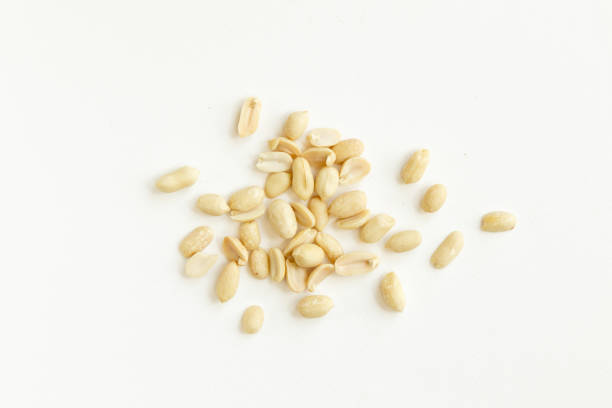 istock Group of peeled peanuts isolated on a white background. 1303497901