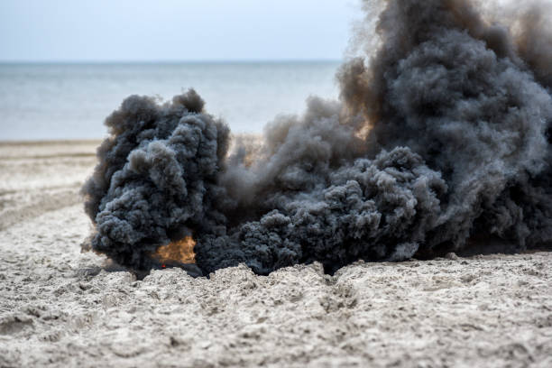 istock Explosion on the beach, billowing black smoke. 1303498059