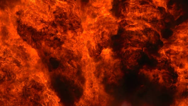 istock Background is a swirling wall of explosive fire. 1303499526