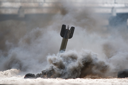 Bomb exploding on the beach, historical reconstruction.