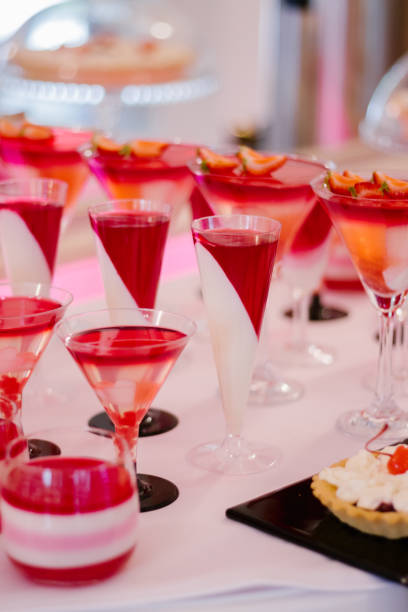 istock Wedding candy bar full of red and white desserts on a white table 1303501148