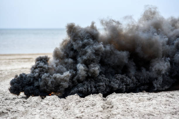 istock Explosion on the beach, billowing black smoke. 1303502050