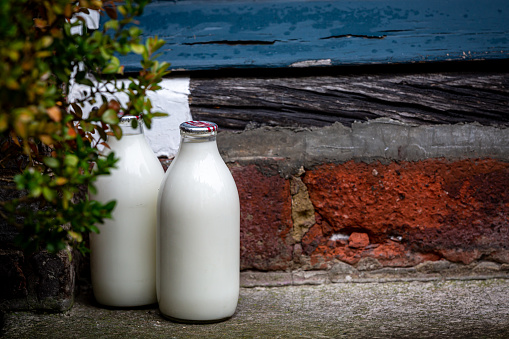 Full milk bottles on a door step in Sussex