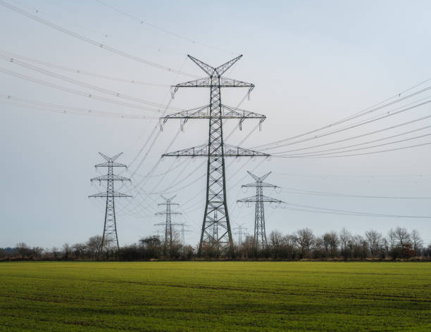 istock Power mast for high voltage electricity infront of blue sky 1303502155
