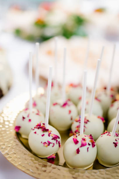 istock Modern dessert white cake pops  on a golden plate close up, candy bar 1303502448
