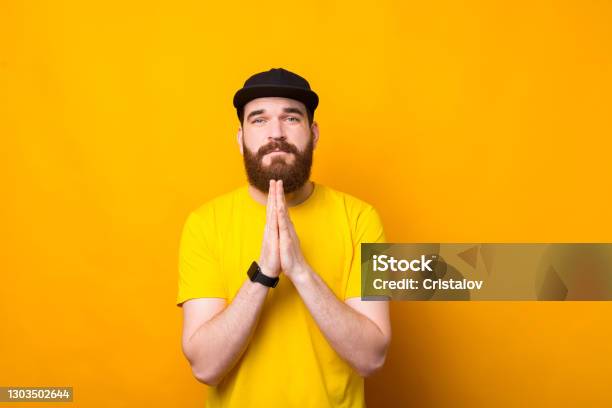 Please Photo Of Young Bearded Man Praying For Something Stock Photo - Download Image Now