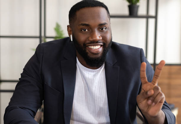 istock Happy young african American student or businessman participate at virtual distant negotiations via teleconference at home. Video call concept 1303502672