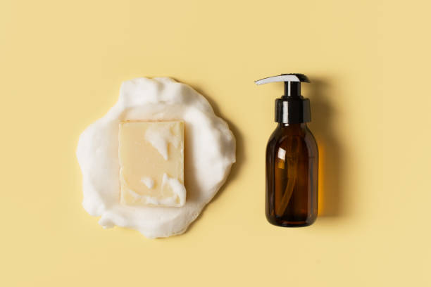Liquid and bar natural eco soap lat lay on yellow background Liquid and bar natural eco soap lat lay on yellow background, copy space, top view bar of soap photos stock pictures, royalty-free photos & images