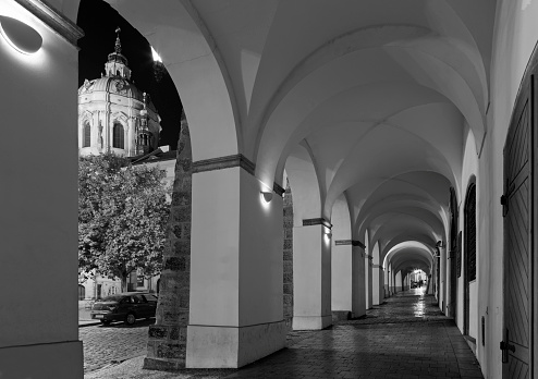 Prague - The porticoes on the Mala Strana quarter with the cupola of St. Nichlas church at night.