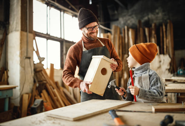 istock Father and son making bird house in workshop 1303505932