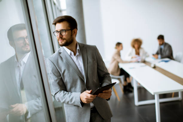 istock Young modern businessman using  digital tablet in the office 1303505946