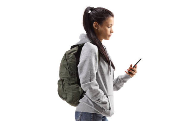 istock Student with a hoodie holding a mobile phone 1303507070