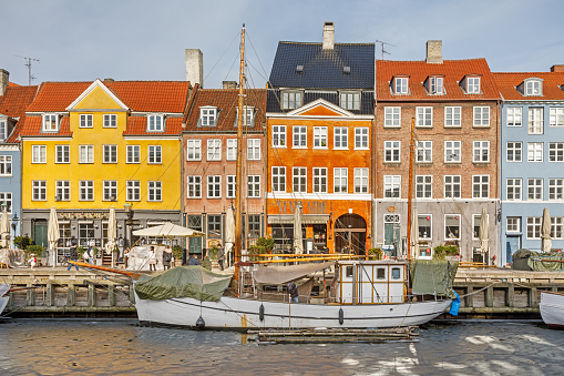 Wooden ships in a frozen harbor in Copenhagen. Despite its name - New Harbor / Nyhavn - this is one of the oldest parts of the Copenhagen harbor and today it is primary a tourist spot and kind of museum for old ships