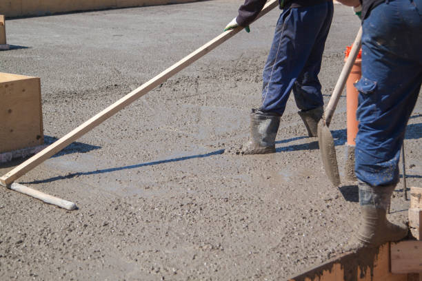 istock worker leveling fresh concrete slab with a special working tool 1303507383