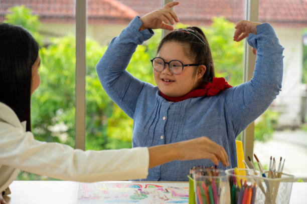 istock Asian AUtism disability child learning in special classroom with teacher 1303508080