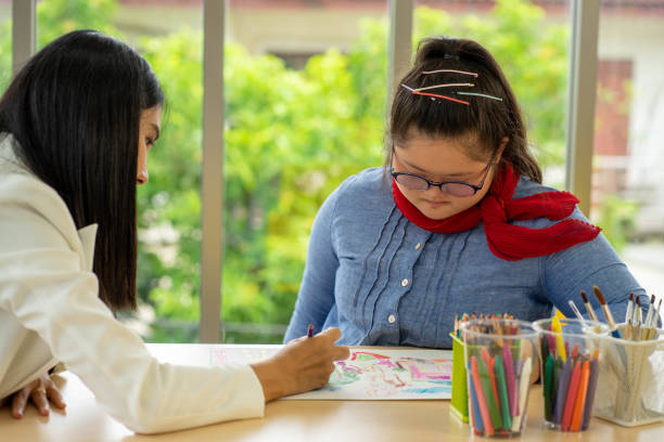 istock Asian AUtism disability child learning in special classroom with teacher 1303508081