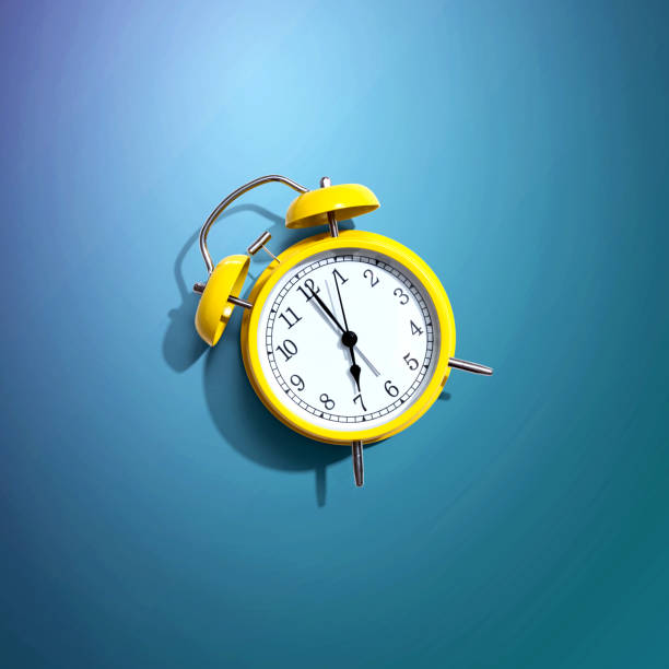istock Yellow vintage alarm clock with shadow 1303509838