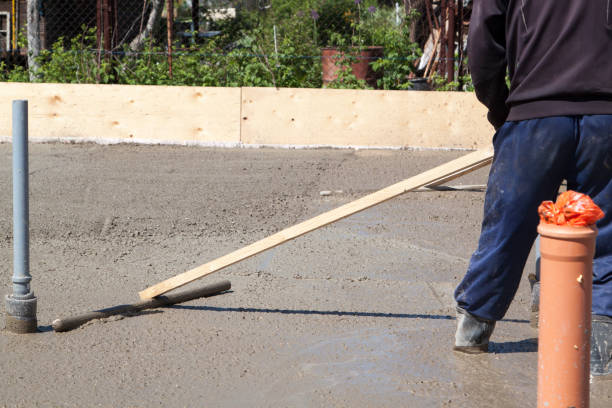 istock worker leveling fresh concrete slab with a special working tool 1303510415
