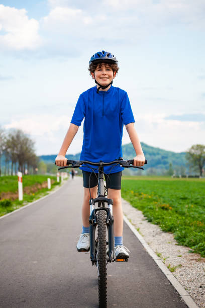 istock Urban biking - boy riding bicycle in city 1303511400