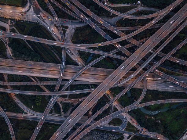 istock Aerial View of Complex Overpass and Busy Traffic at Dusk 1303511526