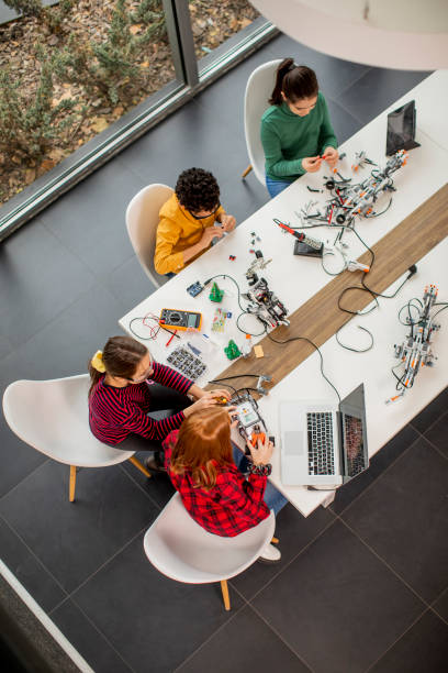istock Happy kids programming electric toys and robots at robotics classroom 1303512624