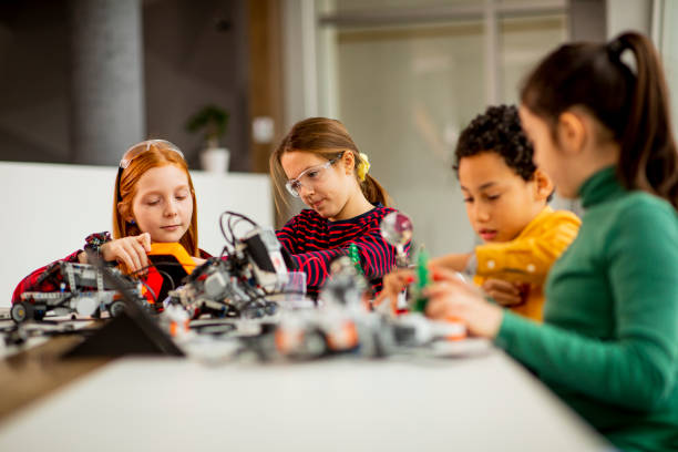 istock Happy kids programming electric toys and robots at robotics classroom 1303512650
