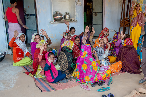 Uttar Pradesh. 05-15-2018. Women working in the textile industry wave goodbye happily. Women apart of taking care of children, they have an important role financial provider of their families.