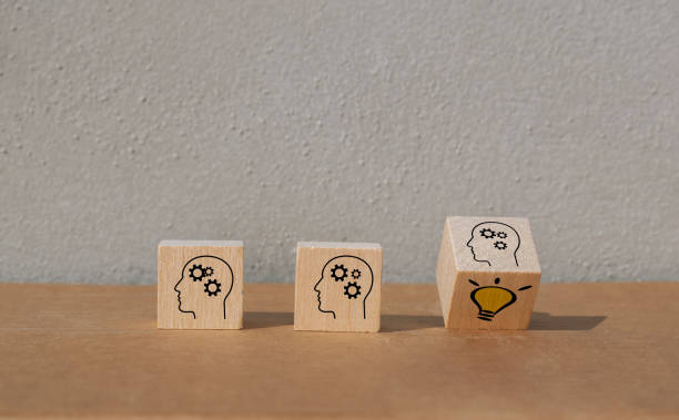 istock Flip over wooden cube block with human head symbol and light bulb icon. Concept creative idea, innovation, team work, team building. 1303515433