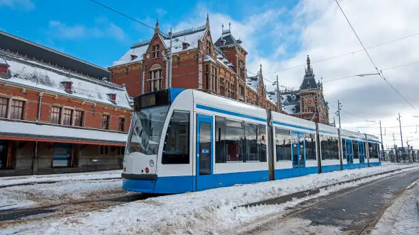 Tram waiting in winter in front of the Central Station in Amsterdam the Netherlands