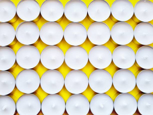 istock unlit candles on yellow background 1303516167
