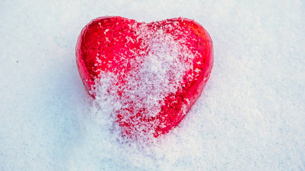 istock Red Valentine's heart in the snow 1303516972