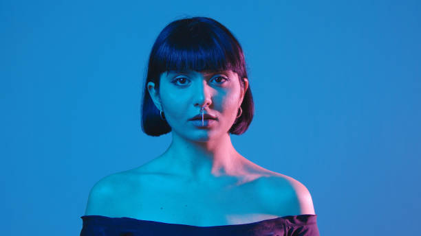 istock Young woman smile isolated on blue neon copyspace 1303517196
