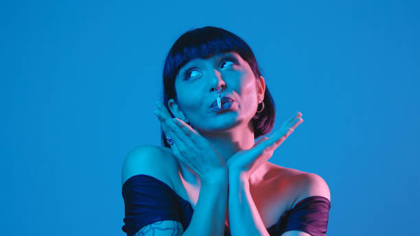 istock Young woman fooling around isolated on blue neon copyspace 1303517235