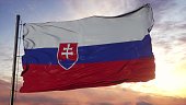 Flag of Slovakia waving in the wind against deep beautiful sky. 3d illustration