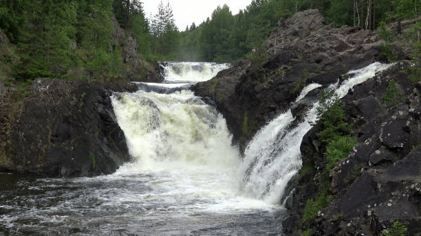 istock Wild Waterfall on the rocks in a wild nature. 1303518606