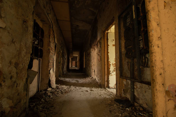 istock dark corridor in old abandoned building 1303519129