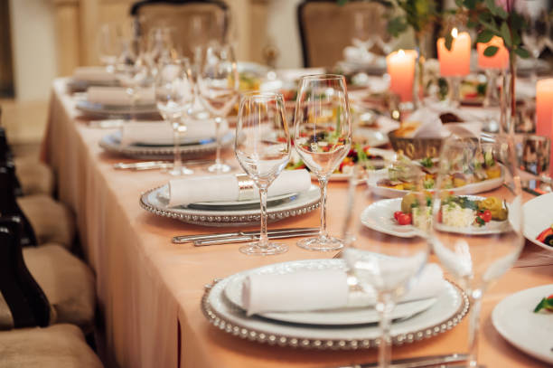 istock Luxurious restaurant. Luxurious interior, white tables, serving dishes and glasses for guests 1303519308
